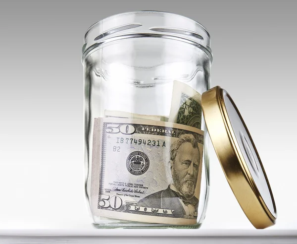 US dollars bank notes in a glass opened jar — Stock Photo, Image