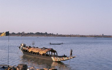 African man pinnace navigating the river Niger clipart