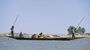 African fisherman pinnace navigating the river Niger clipart