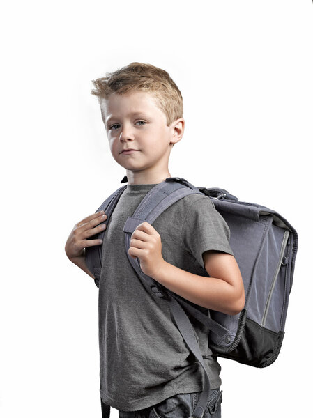 Young boy with backpack isolated on white background