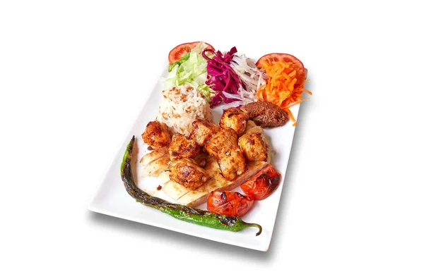 White plate with chicken kebab and vegetables Isolated on withe