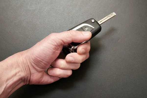 Man Hand Holding Hybrid Key Car Black Wooden Table — Stock Photo, Image