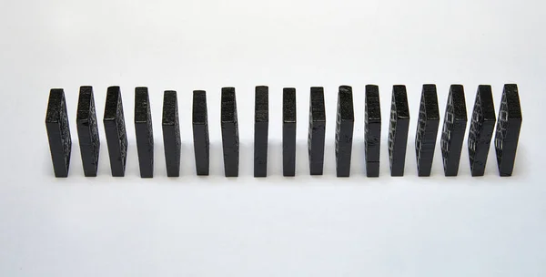 Some Black Dominos Chain White Background — Stockfoto