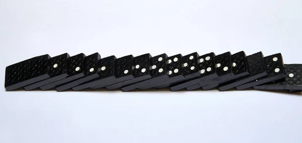 Some Black Dominos Chain White Background — Fotografia de Stock