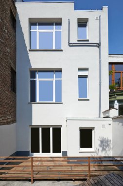 Backyard building facade repair and insulation before and after