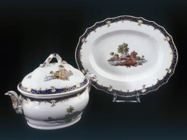 Brussels, Belgium - August 09, 2022:  Set of porcelains from Tournai. Terrine and its tray with Dutch landscapes