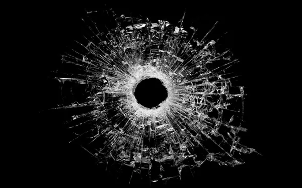 Bullet hole in glass isolated on black — Stock Photo, Image