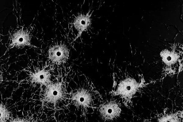 Bullet holes close up isolated on black — Stock Photo, Image