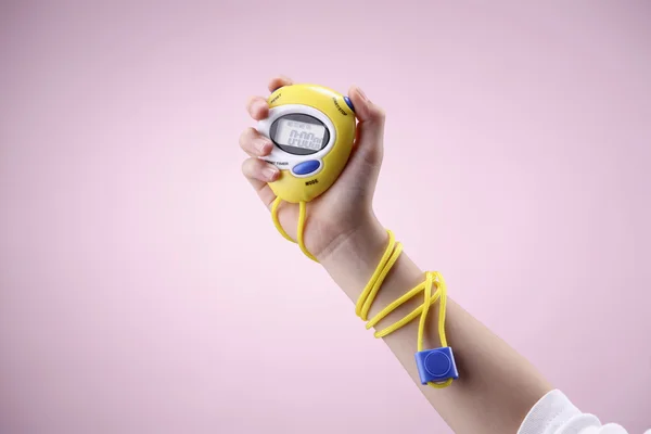 Kid holding a digital stopwatch — Stock Photo, Image