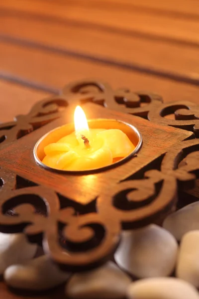 Candle with asian design on stone — Stock Photo, Image