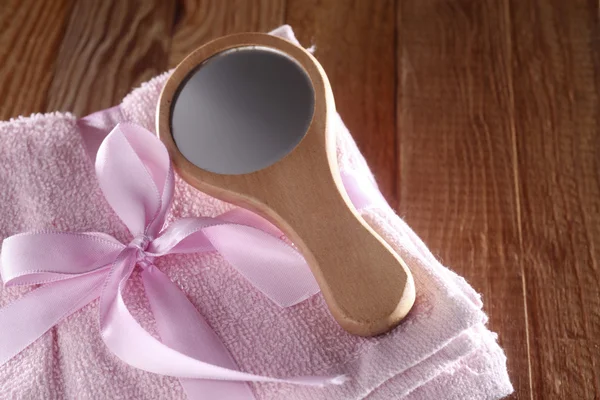 Mirror resting on stack of towel — Stock Photo, Image