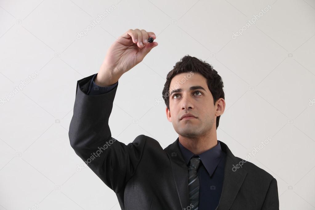 Businessman holding marker pen with copy space
