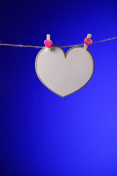 Peper cut heart shape hanging on washing line. — Stock Photo, Image