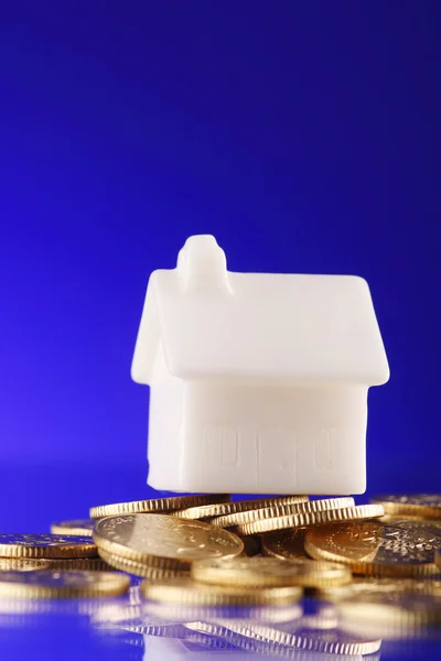 Close-up de uma casa modelo em uma pilha de moedas — Fotografia de Stock