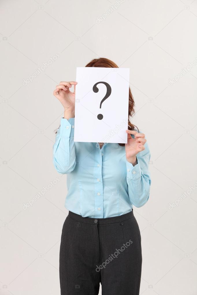 Woman holding a paper printed a big question mark