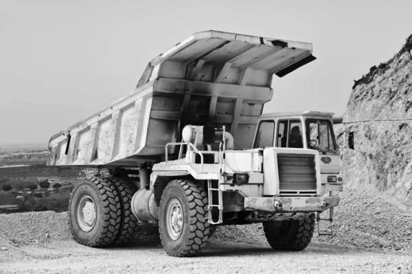 Stone pit with industrial vehicle at work — Stock Photo, Image