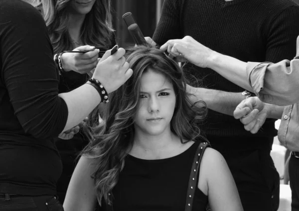 Young girl having her hair combed by hairdressers, Italy, Sicily — Stock Photo, Image