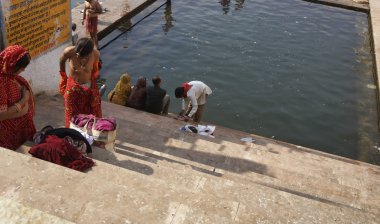 Indian pilgrims take a bath in the sacred lake