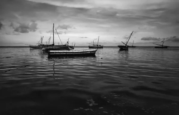 Kenya, Malindi, local fishing boats in shallow water with low tide after sunset — Stock Photo, Image