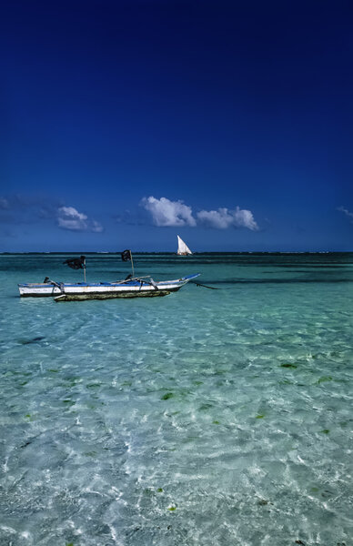 Kenya, Indian ocean, Malindi, view of a local fishing boat in shallow water