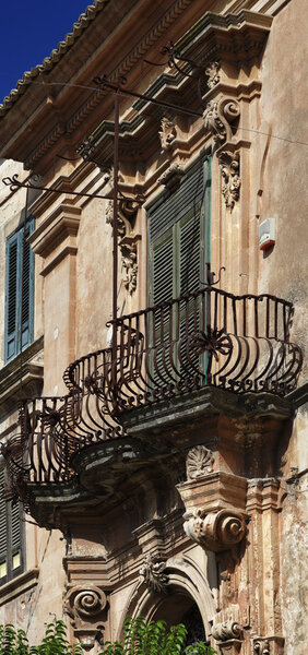 Italy, Sicily, Ragusa, baroque building facade, original balcony