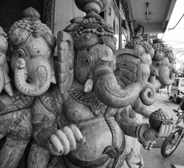 Wooden hindu Ganesh God statue for sale in a local store clipart