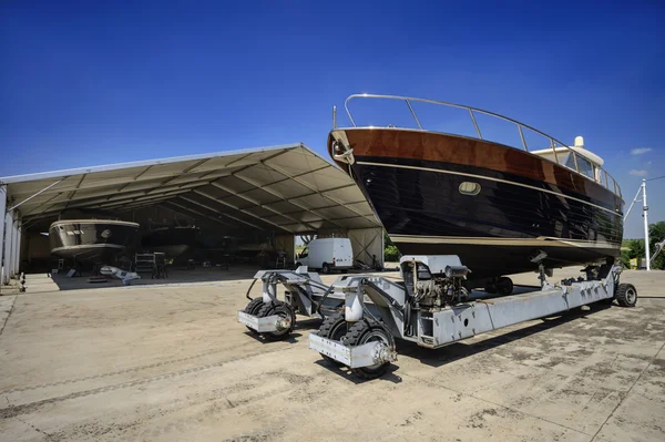 Luxury yacht ashore in a boatyard — Stock Photo, Image