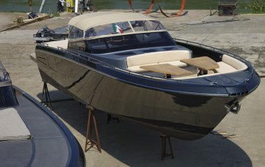 Luxury yachts ashore in a boatyard clipart