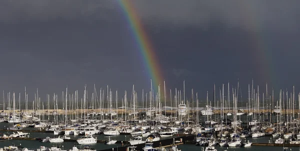 Yachts in the marina with a rainbow — Stock Photo, Image