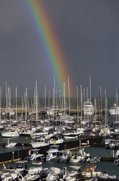 Yachts in the marina with a rainbow — Stock Photo, Image