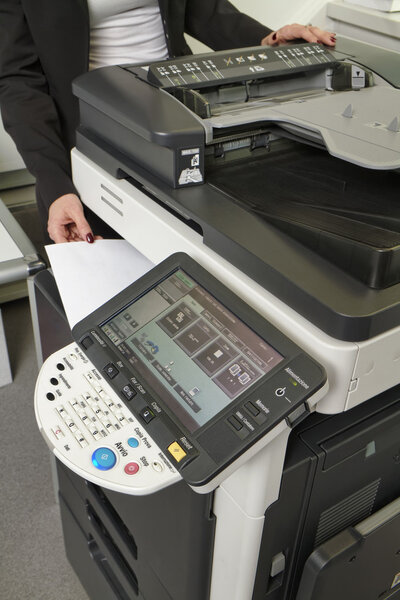 Woman using a xerox machine at the office