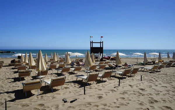 Палубные стулья и пляжные зонтики — стоковое фото