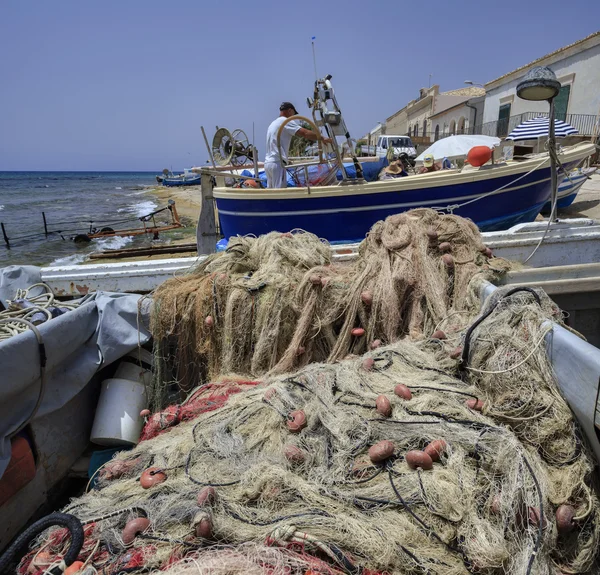 Fisherman working ashore on his fishing boat