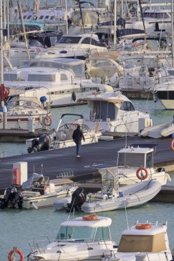 İtalya, Sicilya, Akdeniz, Marina di Ragusa (Ragusa Eyaleti); 6 Aralık 2021, limandaki insanlar, motorlu tekneler ve lüks yatlar - EDITORIAL