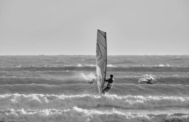 İtalya, Sicilya, Akdeniz, Marina di Ragusa (Ragusa ili); 7 Aralık 2021, denizde rüzgar sörfçüleri - EDITORIAL