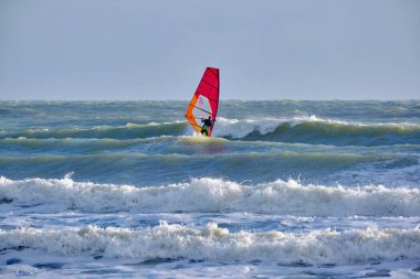 İtalya, Sicilya, Akdeniz, Marina di Ragusa (Ragusa ili); 7 Aralık 2021, denizde rüzgar sörfçüsü - EDITORIAL