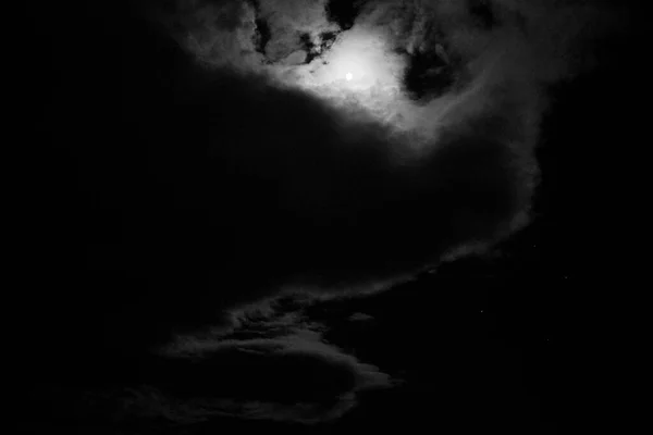 View of the moon and clouds in the sky at night