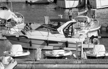 İtalya, Sicilya, Akdeniz, Marina di Ragusa (Ragusa Eyaleti); 17 Temmuz 2022, limanda lüks bir yatta insanlar - EDITORIAL