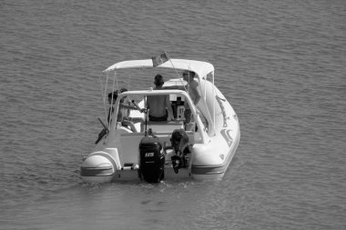 İtalya, Sicilya, Akdeniz, Marina di Ragusa (Ragusa Eyaleti); 23 Temmuz 2022, limandaki kauçuk bir teknede insanlar - EDITORIAL