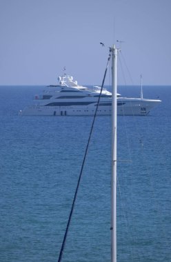 Italy, Sicily, Mediterranean sea, Marina di Ragusa, sailing boat mast in the port and a big luxury yacht in the background