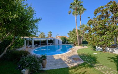 Italy, Sicily, Ragusa Province, countryside; 29 July 2022, elegant private house, view of the swimming pool and the garden - EDITORIAL