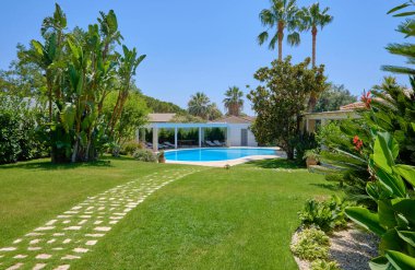 Italy, Sicily, Ragusa Province, countryside; 29 July 2022, elegant private house, view of the swimming pool and the garden - EDITORIAL