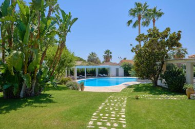 Italy, Sicily, Ragusa Province, countryside; 29 July 2022, elegant private house, view of the swimming pool and the garden - EDITORIAL