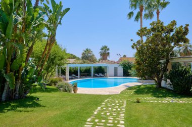 Italy, Sicily, Ragusa Province, countryside; 29 July 2022, elegant private house, view of the swimming pool and the garden - EDITORIAL