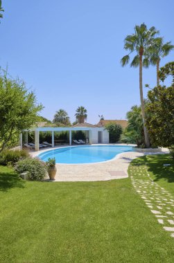 Italy, Sicily, Ragusa Province, countryside; 29 July 2022, elegant private house, view of the swimming pool and the garden - EDITORIAL