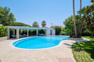 Italy, Sicily, Ragusa Province, countryside; 29 July 2022, elegant private house, view of the swimming pool and the garden - EDITORIAL