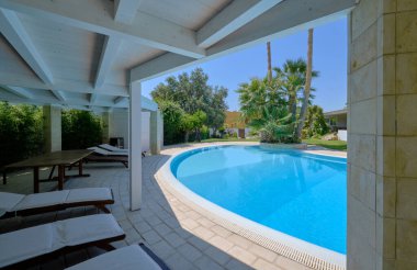 Italy, Sicily, Ragusa Province, countryside; 29 July 2022, elegant private house, view of the swimming pool and the garden - EDITORIAL
