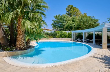 Italy, Sicily, Ragusa Province, countryside; 29 July 2022, elegant private house, view of the swimming pool and the garden - EDITORIAL