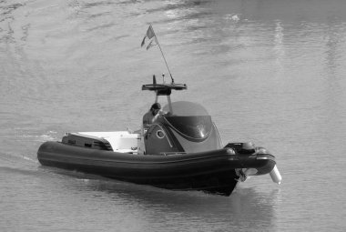 Italy, Sicily, Mediterranean Sea, Marina di Ragusa (Ragusa Province); 3 August 2022, men on a big rubber boat in the port - EDITORIAL