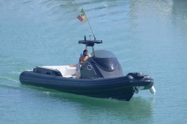 Italy, Sicily, Mediterranean Sea, Marina di Ragusa (Ragusa Province); 3 August 2022, men on a big rubber boat in the port - EDITORIAL